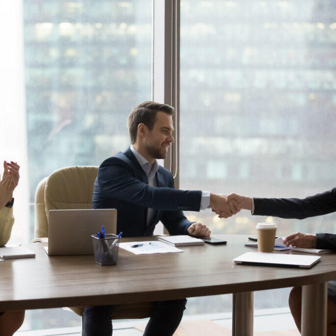 Happy,Middle,Aged,Executive,Businesswoman,Handshaking,New,Male,Partner,At