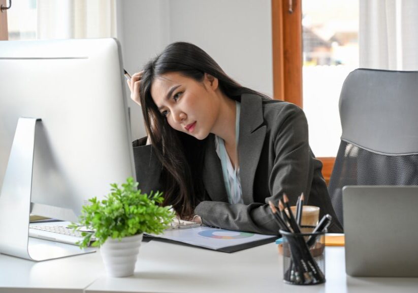 A,Tired,Businesswoman,Sits,At,Her,Desk,In,The,Office,